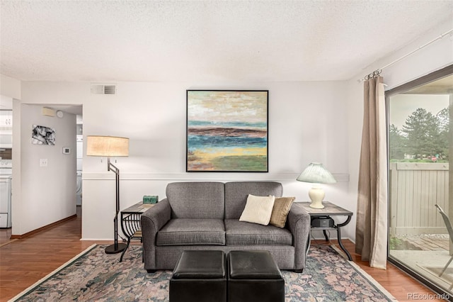 7750 W 87th Dr Unit C, Arvada, CO 80005 - living room featuring wood finished floors and a textured ceiling