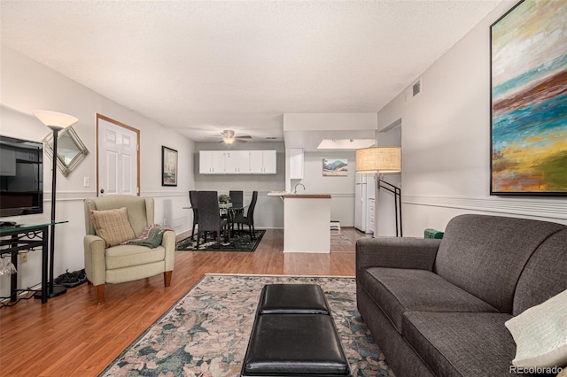 7750 W 87th Dr Unit C, Arvada, CO 80005 - living room with light wood-style floors and ceiling fan