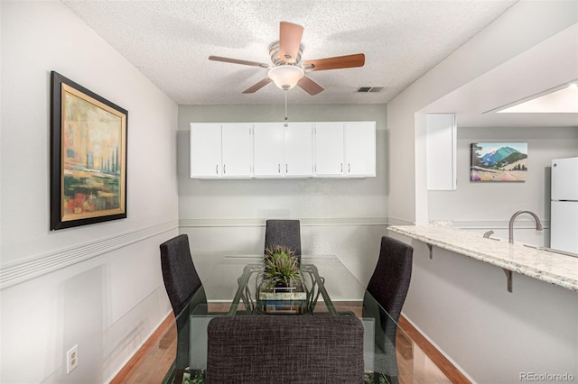 7750 W 87th Dr Unit C, Arvada, CO 80005 - dining room featuring a textured ceiling, wood finished floors, ceiling fan, and a desk