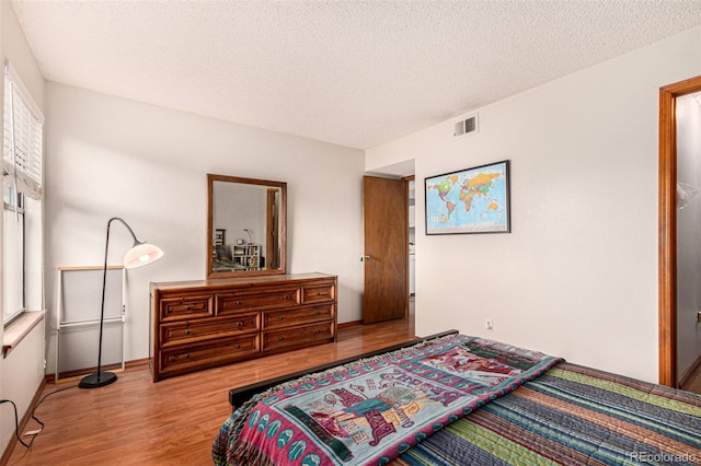 7750 W 87th Dr Unit C, Arvada, CO 80005 - bedroom featuring wood finished floors and a textured ceiling