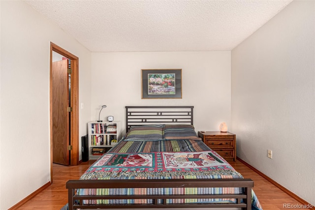 7750 W 87th Dr Unit C, Arvada, CO 80005 - bedroom featuring wood finished floors and a textured ceiling