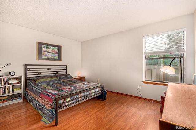 7750 W 87th Dr Unit C, Arvada, CO 80005 - bedroom featuring wood finished floors and a textured ceiling