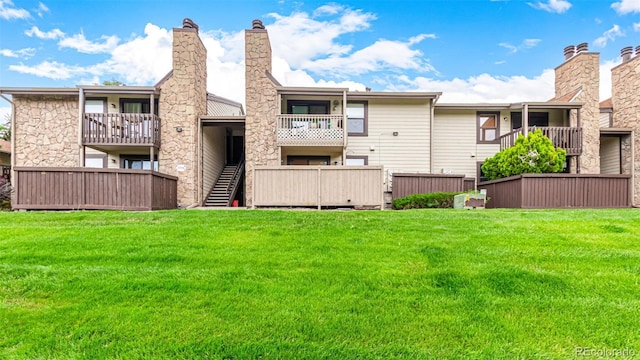 7750 W 87th Dr Unit C, Arvada, CO 80005 - back of house with a lawn, a chimney, and stairway