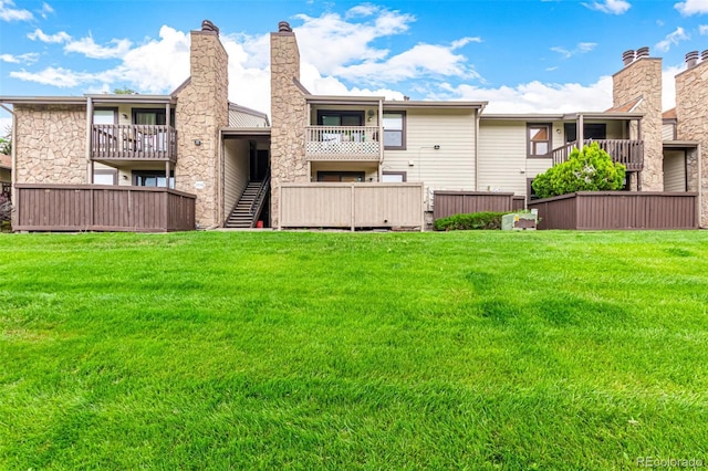 7750 W 87th Dr Unit C, Arvada, CO 80005 - back of house featuring a yard and a chimney