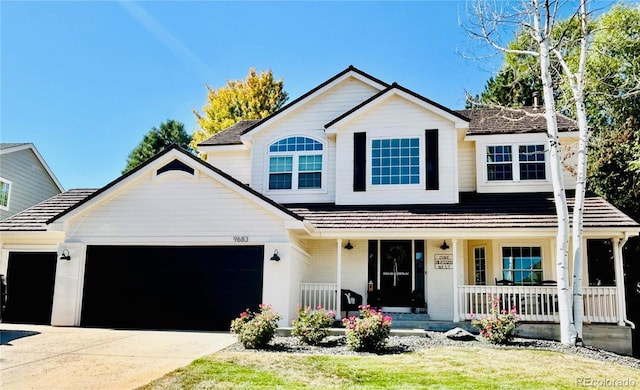 view of front of house with covered porch, concrete driveway, and a garage