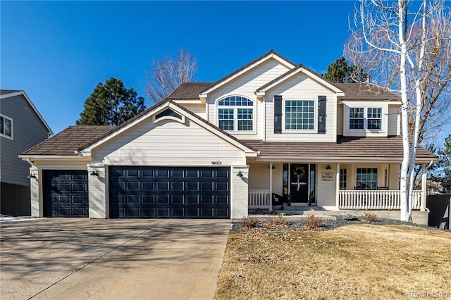 traditional home featuring a garage, brick siding, a porch, and concrete driveway