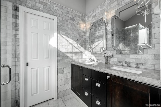 bathroom featuring double vanity, a shower stall, tile walls, and a sink