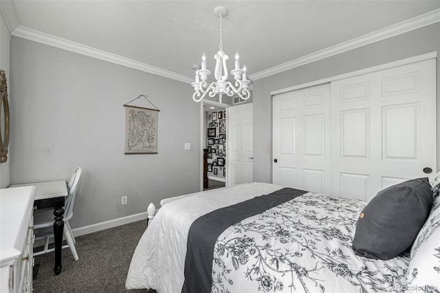 carpeted bedroom with ornamental molding, baseboards, a closet, and a chandelier