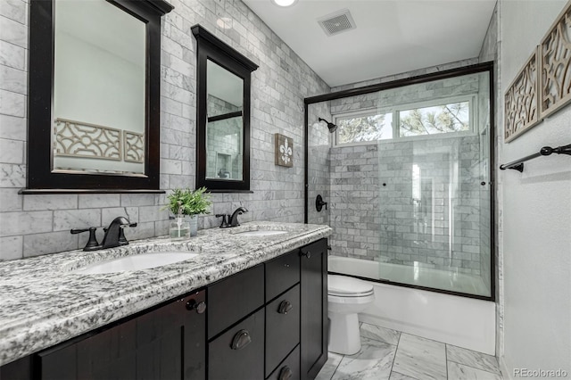 bathroom with visible vents, marble finish floor, toilet, and a sink