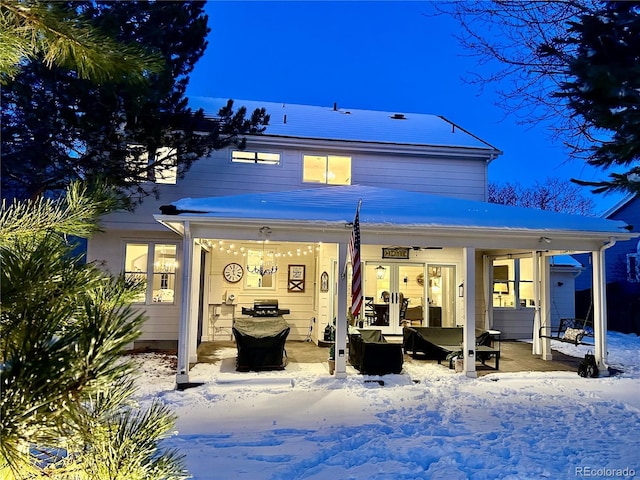 snow covered property with an outdoor hangout area and a patio