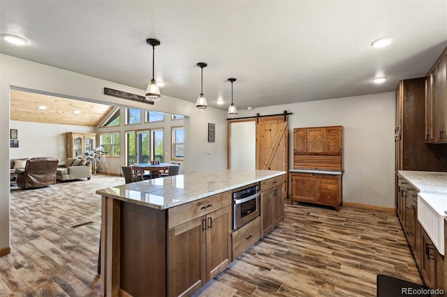 116 County Road 414, Granby, CO 80446 - kitchen with a barn door, dark wood-type flooring, a kitchen island, pendant lighting, and recessed lighting