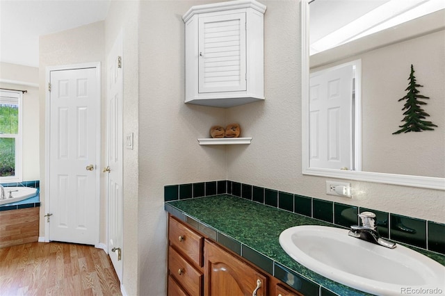116 County Road 414, Granby, CO 80446 - bathroom with vanity, wood finished floors, and a tub to relax in