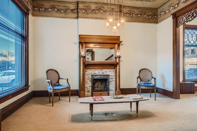 sitting room with an inviting chandelier and light colored carpet