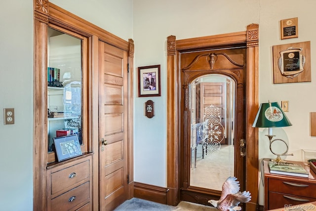 doorway to outside with light colored carpet