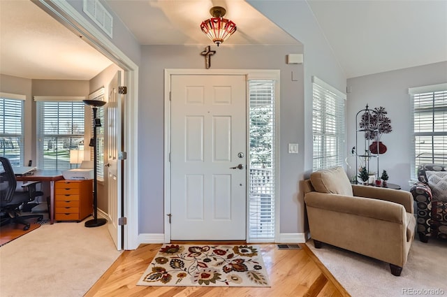 foyer entrance featuring light wood-style floors, baseboards, and visible vents