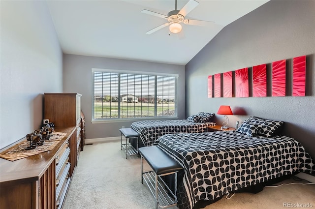 bedroom with a ceiling fan, baseboards, light carpet, and lofted ceiling