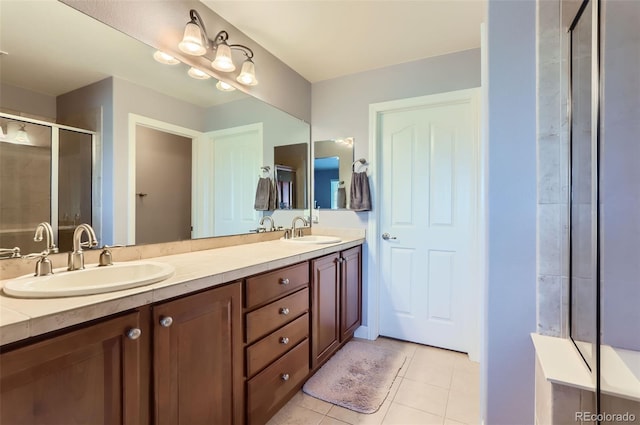 full bathroom featuring tile patterned flooring, a sink, double vanity, and a shower stall