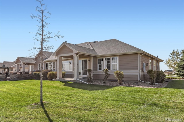 rear view of property with a lawn