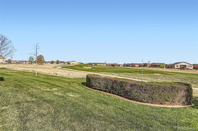 surrounding community with a lawn and a residential view