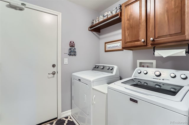 laundry room featuring cabinet space and washer and clothes dryer