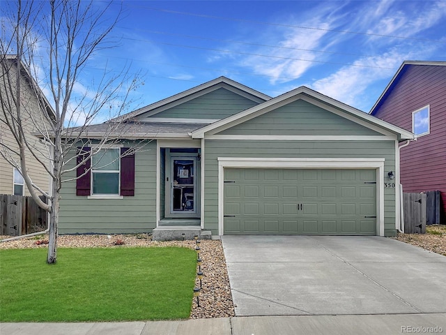 single story home with an attached garage, a front lawn, fence, and driveway
