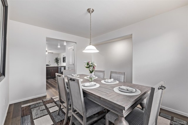 dining room with baseboards, a ceiling fan, and wood finished floors