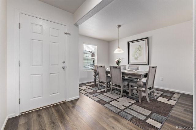 dining area with baseboards and wood finished floors