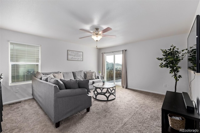 carpeted living area with ceiling fan, visible vents, and baseboards