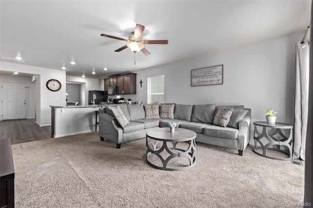 living area with a ceiling fan, baseboards, recessed lighting, and dark colored carpet