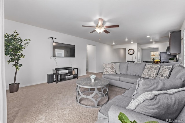 carpeted living room featuring recessed lighting, a ceiling fan, and baseboards