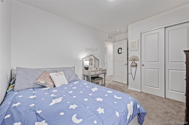 bedroom with visible vents, carpet, and a closet