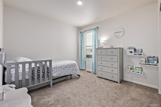 carpeted bedroom featuring baseboards