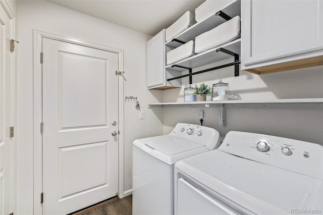 laundry area featuring separate washer and dryer, dark wood finished floors, and cabinet space