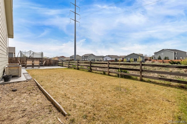 view of yard with a fenced backyard, a patio, and a residential view