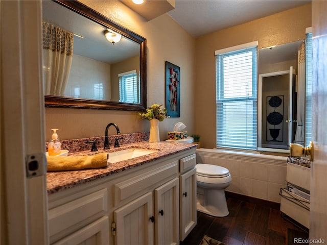 8908 Jellison Ct, Westminster, CO 80021 - full bath with plenty of natural light, toilet, wood finished floors, and vanity