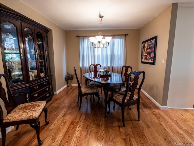 8908 Jellison Ct, Westminster, CO 80021 - dining area featuring a chandelier, baseboards, and light wood finished floors