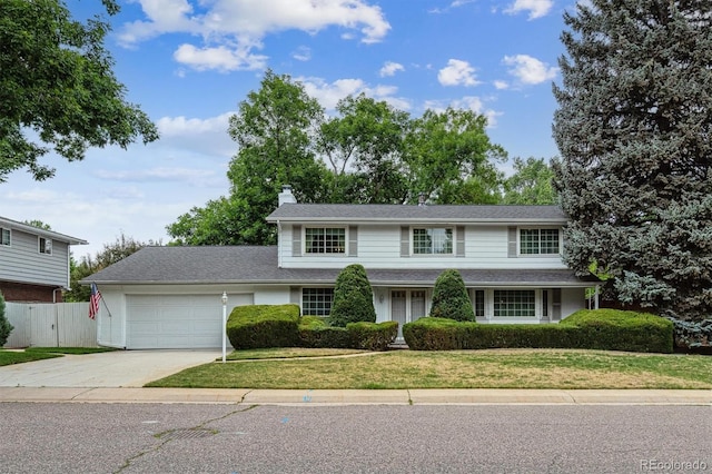 7129 S Marshall St, Littleton, CO 80128 - traditional-style house with a chimney, an attached garage, and driveway