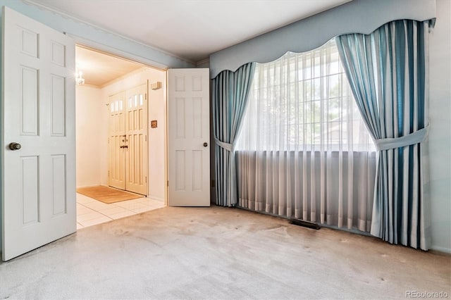 7129 S Marshall St, Littleton, CO 80128 - carpeted empty room featuring crown molding and tile patterned floors