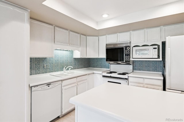 7129 S Marshall St, Littleton, CO 80128 - kitchen featuring white appliances, light countertops, white cabinets, wallpapered walls, and light wood-style flooring