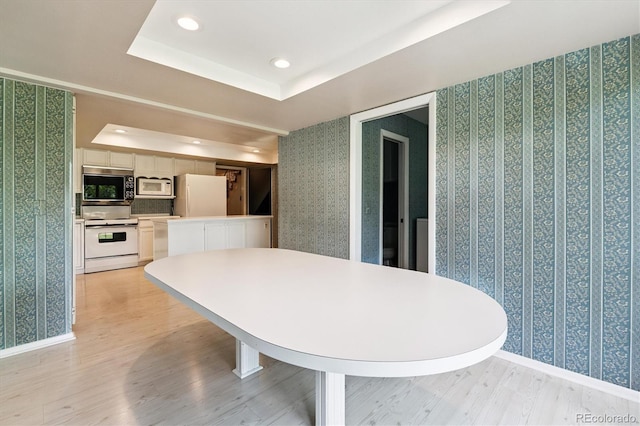 7129 S Marshall St, Littleton, CO 80128 - dining area featuring wallpapered walls, light wood-style floors, recessed lighting, and a raised ceiling