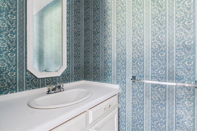 7129 S Marshall St, Littleton, CO 80128 - bathroom featuring wallpapered walls and vanity