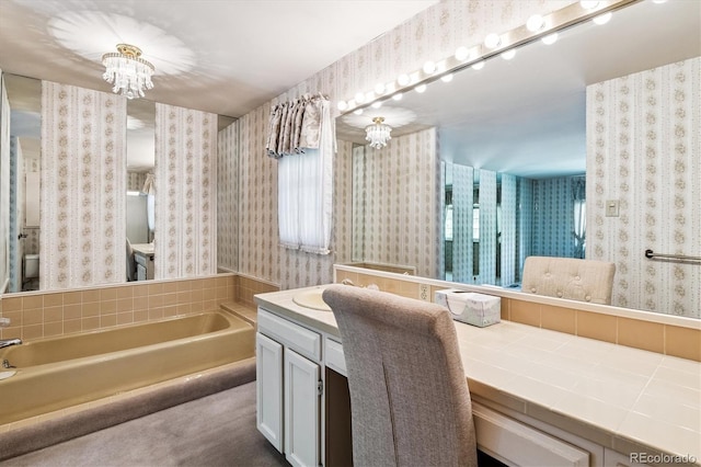 7129 S Marshall St, Littleton, CO 80128 - bathroom featuring a garden tub, vanity, wallpapered walls, and a chandelier