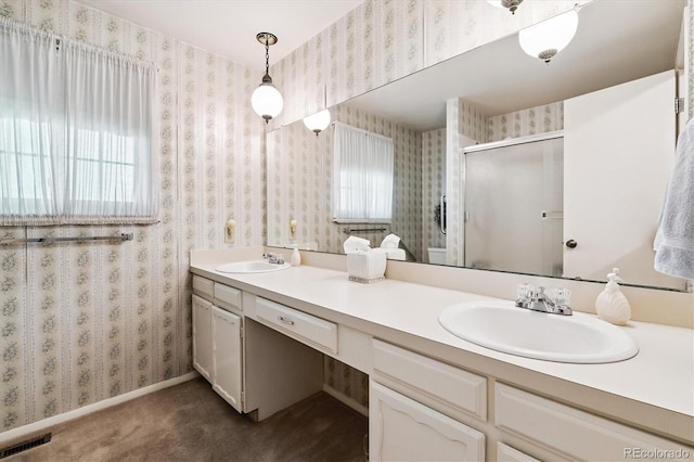 7129 S Marshall St, Littleton, CO 80128 - bathroom with double vanity, a stall shower, healthy amount of natural light, and wallpapered walls