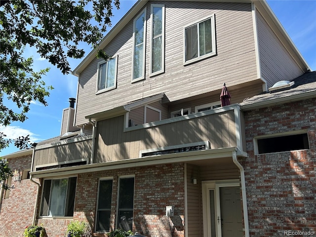 view of home's exterior with a balcony