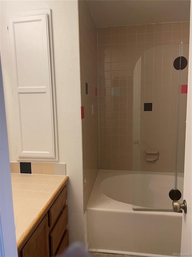 bathroom with vanity and tiled shower / bath combo