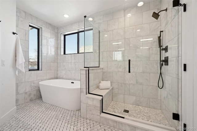 bathroom featuring tile patterned flooring, shower with separate bathtub, and tile walls