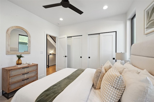 bedroom with multiple closets and ceiling fan