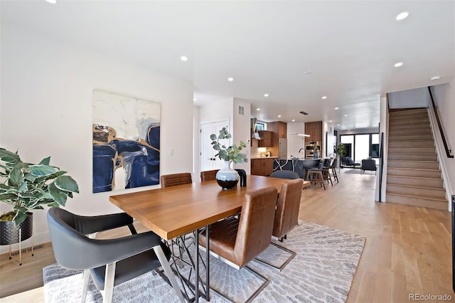 dining space with light wood-type flooring