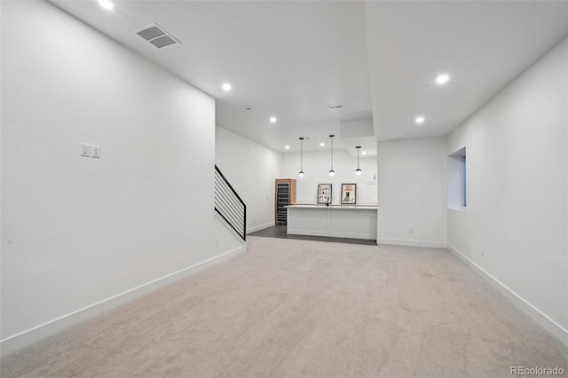 unfurnished living room featuring light colored carpet