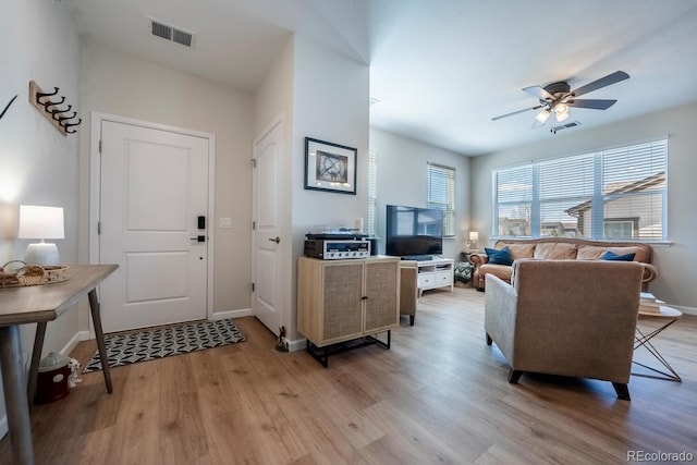 foyer entrance with light wood-style flooring, visible vents, baseboards, and ceiling fan